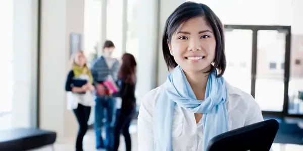 Female college student holding books.