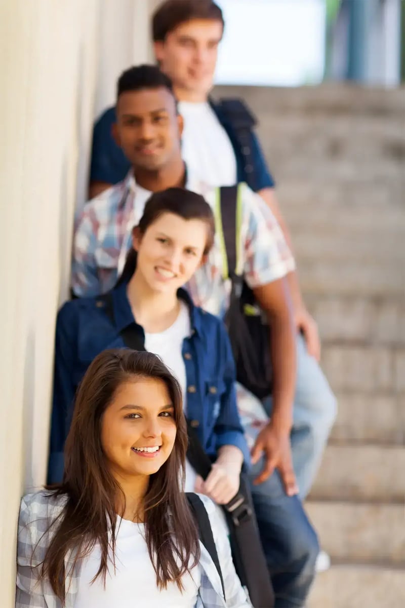 students linws up in row on stairs on a campus.